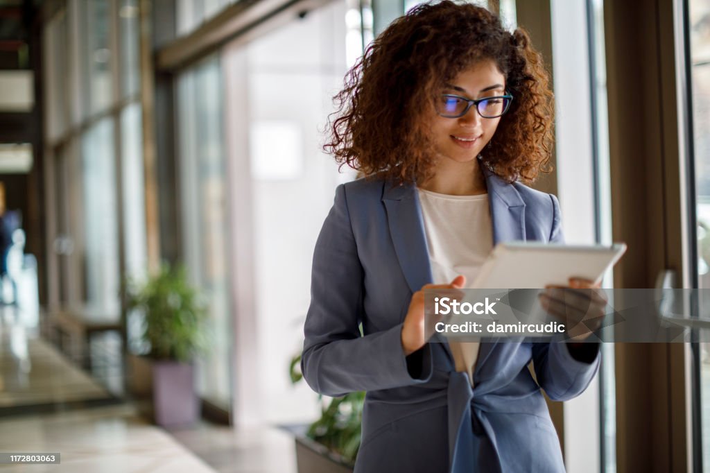 Young businesswoman using digital tablet indoors Digital Tablet Stock Photo