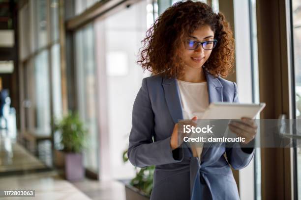 Young Businesswoman Using Digital Tablet Indoors Stock Photo - Download Image Now - Digital Tablet, Office, Women
