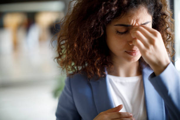 istock Young woman having a headache from working 1172803172