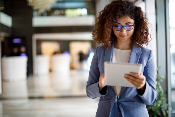 istock Young businesswoman using digital tablet indoors 1172803259