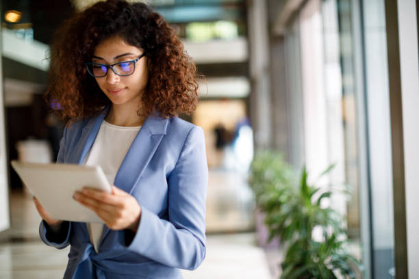 istock Young businesswoman using digital tablet indoors 1172803265