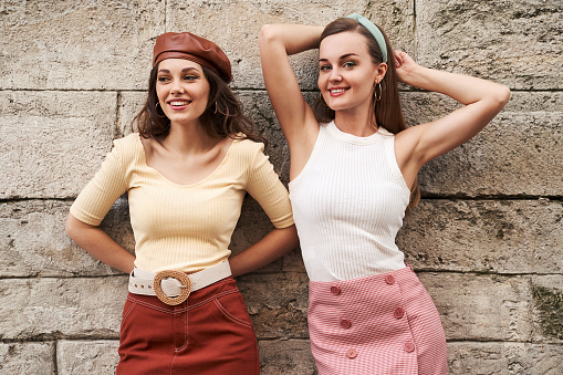 Young beautiful girls dressed in retro vintage style enjoying the old european city summertime lifestyle