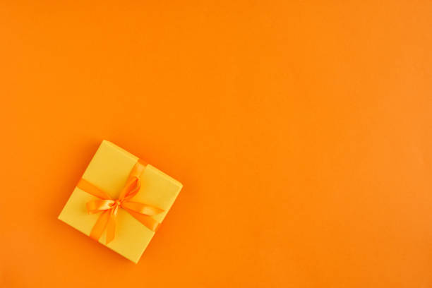 istock Gift box with ribbon and bow on color background and space for text. Top view 1172805065