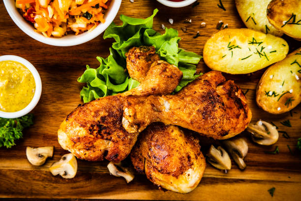 istock Roast chicken legs with fried potatoes and vegetables 1172809417