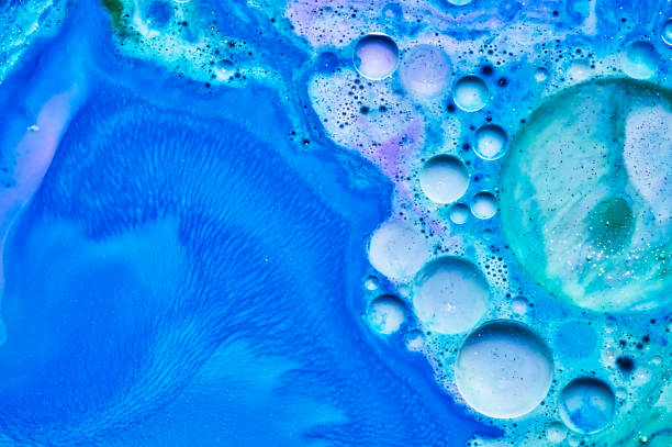 istock mixing blue white and purple color paints on blue background 1172809982
