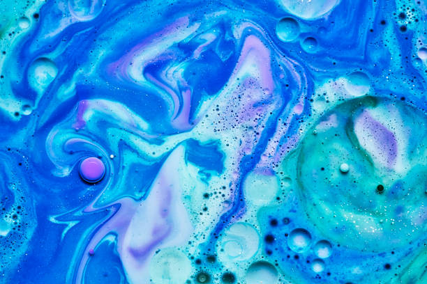 istock mixing blue white and purple color paints on blue background 1172809996