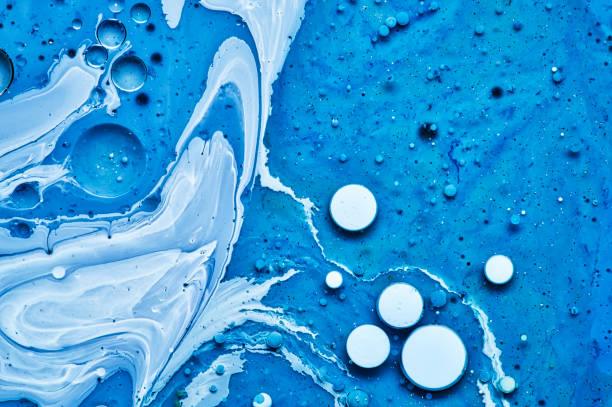 istock mixing blue white and purple color paints on blue background 1172810005