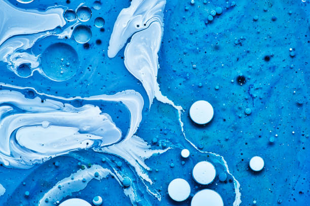 istock mixing blue white and purple color paints on blue background 1172810014