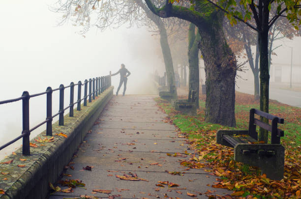 Beautiful young woman outdoors on a misty autumn day.