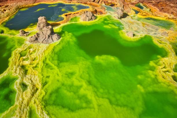 Sulfur deposits in the desert of Dallol, Ethiopia Dallol, Ethiopia - January 03, 2019: Yellowish green deposits which include potash, green acid and iron oxide, sulfur and salt desert plains, being also the hottest place on earth. danakil depression stock pictures, royalty-free photos & images