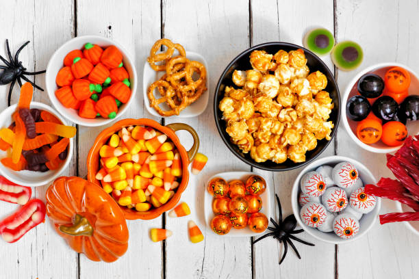 istock Halloween candy buffet table top view over a white wood background 1172822613