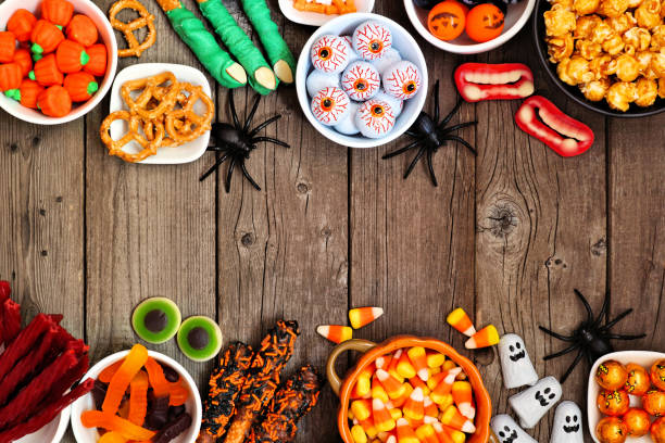 istock Halloween candy buffet table double border over a rustic wood background with copy space 1172822832