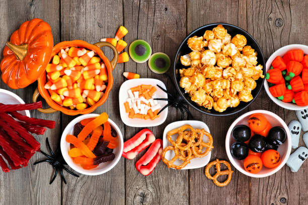 istock Halloween candy buffet table top view over a rustic wood background 1172823385