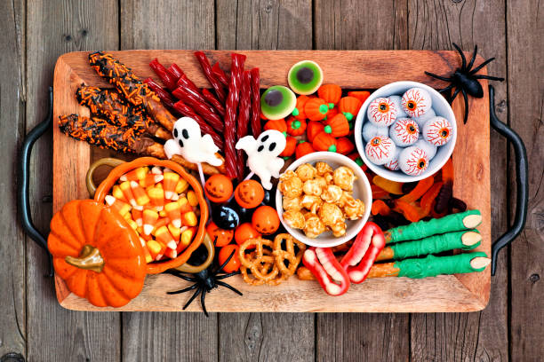 istock Halloween candy tray, top view over a rustic wood background 1172823591