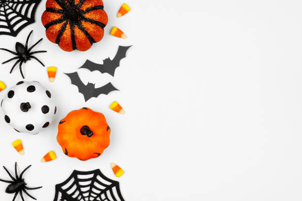 istock Halloween side border flat lay of pumpkins, candy and decor, over a white background 1172823655