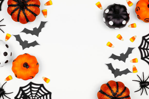 istock Halloween double side border flat lay of pumpkins, candy and decor, over a white background 1172823826