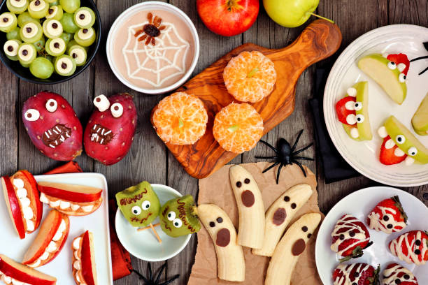 istock Healthy Halloween fruit treats, top view table scene over a rustic wood background 1172825089