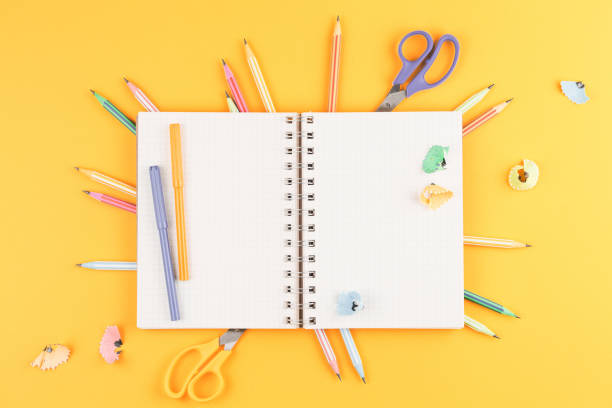 istock notebook on a yellow isolated background, office supplies 1172826241