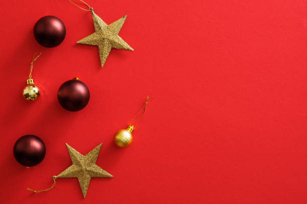 istock Christmas ornaments decorations on red background with copy space. Flat lay red baubles balls, golden stars, glitter confetti. Christmas cover mockup, greeting card template, social media Xmas banner 1172826962