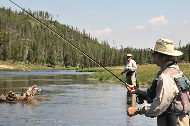 flyfishing casal idoso - ankle deep in water imagens e fotografias de stock