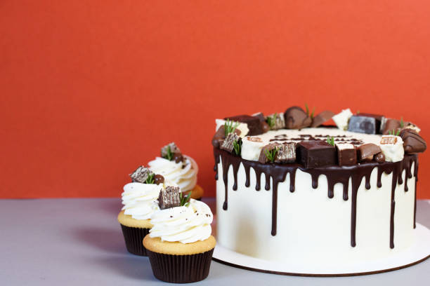 istock Beautiful festive cake with decor and chocolate on a red background. 1172833883