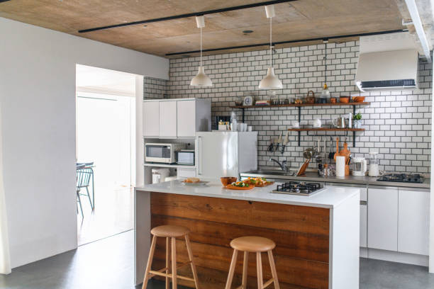 General view of fully equipped kitchen in modern Japanese home with prepared lunch on the island counter.