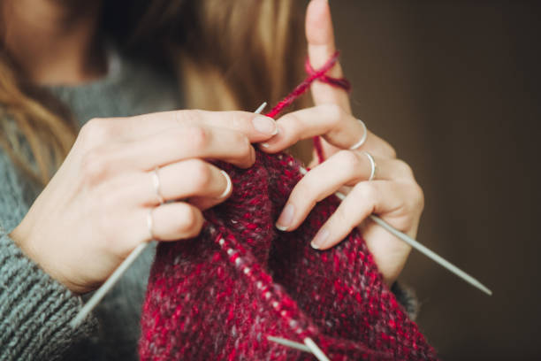 istock Close up on woman's hands knitting 1172836801