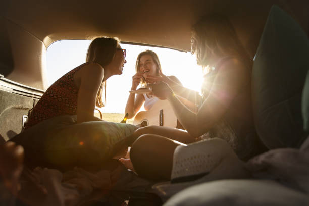 istock Girlfriends laughing after sharing snacks on their camping trip 1172836821