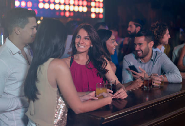 istock Happy group of people having drinks at the bar 1172845189