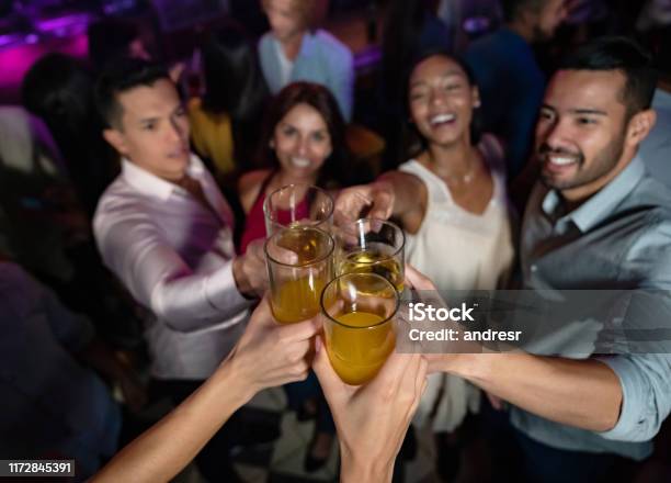 Happy Group Of Friends At The Nightclub Making A Toast Stock Photo - Download Image Now