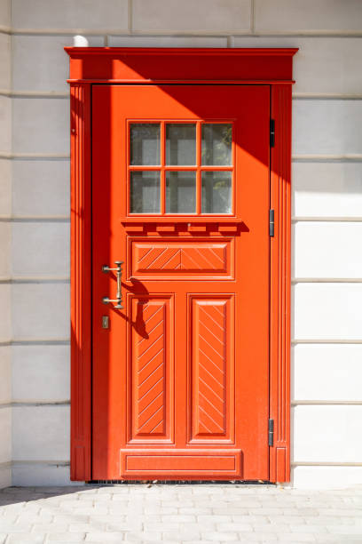 istock red wooden front door in a white stone wall 1172845625