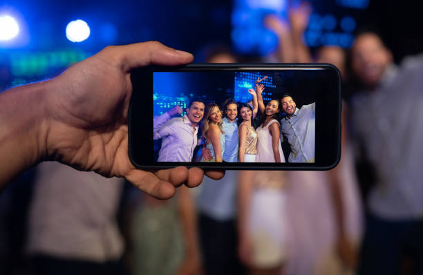 istock Taking a picture at the nightclub using a cell phone 1172846312