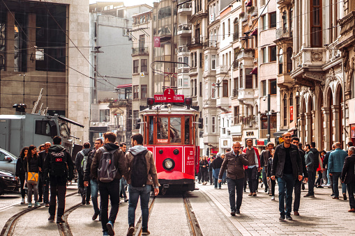 April 17, 2019 : Red tram on crowded Istiklal Avenue in Taksim, Istanbul