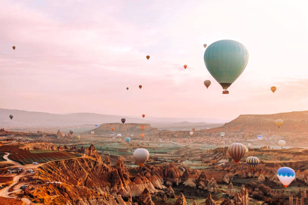 colorful hot air balloons flying over the valley at cappadocia sunrise time popular travel destination in turkey - cappadocia hot air balloon turkey basket imagens e fotografias de stock