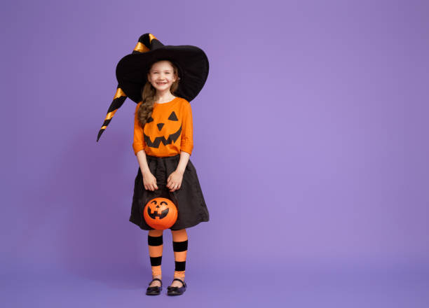 istock little witch on purple background 1172852117