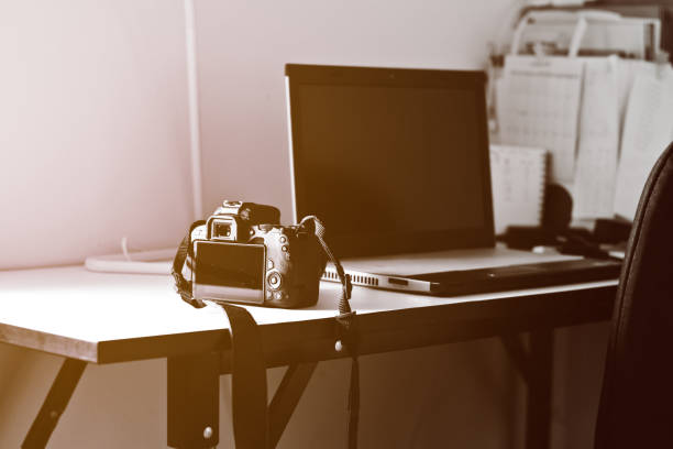 istock The camera and laptop on the table 1172860610