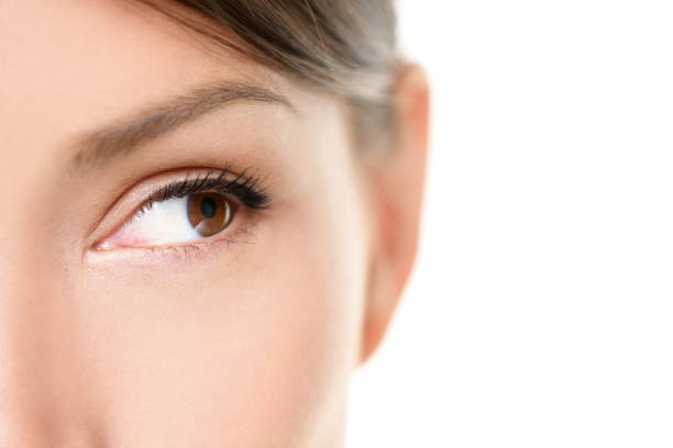 istock Eye close up - brown eyes looking to side on white 1172861634