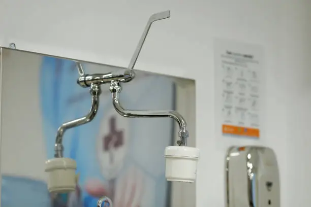 Faucet water filter system on the sink in hospital