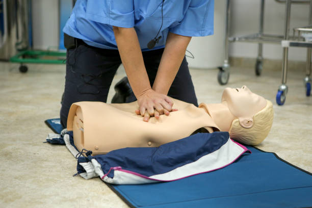 istock Woman medic demonstrates CPR methods on a plastic mannequin 1172864595