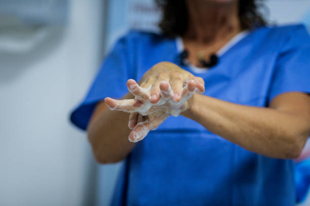 istock Details with a medic washing her hands before a medical procedure 1172864596