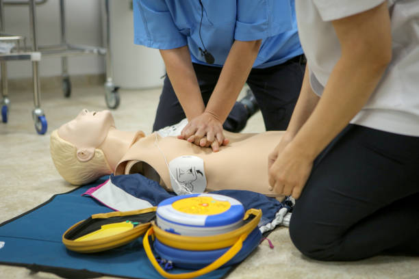 istock Woman medic demonstrates CPR methods on a plastic mannequin 1172864649