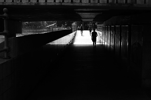 people walking along underpass