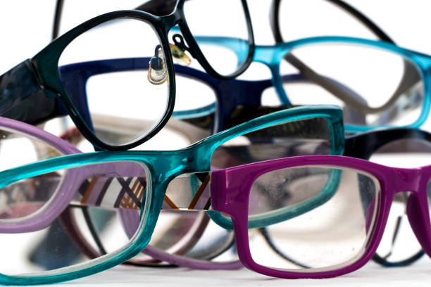 istock multiple colored eye glasses in a pile on white background. Eye Health Concept 1172869987