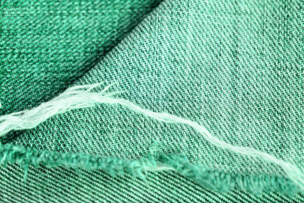 istock Old jeans texture close up. Green denim background 1172870881