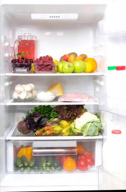istock n a white refrigerator, on the top shelf fruits, berries and a jug with compote, on medium mushrooms, poultry meat, cottage cheese, cheese, eggs, on the bottom vegetables, and in the door dairy products, kefir, cream 1172873826