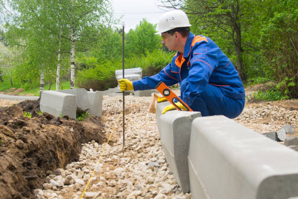 istock master in blue form sets the post with the control thread, for smooth laying curbstone 1172873893