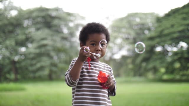 African Children blowing bubbles in slow motion