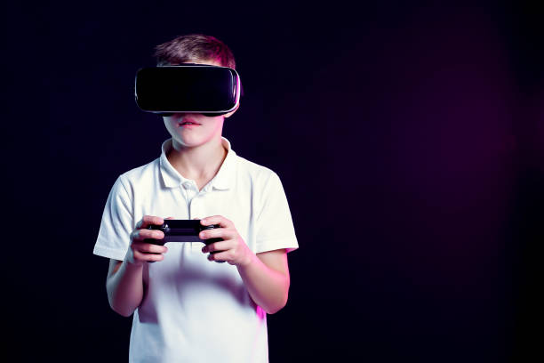 istock Boy in VR goggles playing with gamepad 1172880943