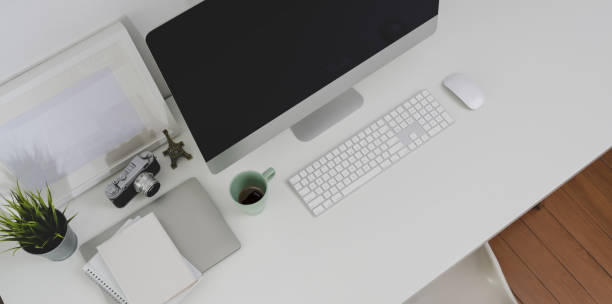 istock Top view of desktop computer and office supplies with copy space in minimal office room 1172881135