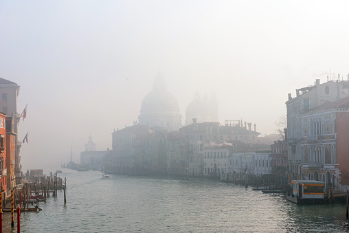 Panoramic view of famous Grand Canal in the winter in Venice, Italy. Scenic postcard view of the famous Santa Maria della Salute on the Grand Canal in the winter morning.